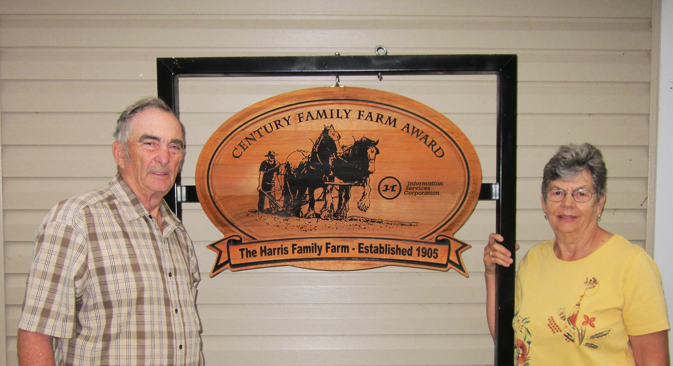 Harris family members with the Century Family Farm Award